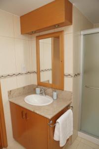 a bathroom with a sink and a mirror at Anthorina Villa 19 in Protaras