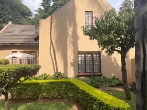 a house with a garden in front of it at Lalakamnandi Guesthouse in Pretoria