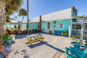 a blue building with a picnic table in front of it at Flagler Suites 1 in New Smyrna Beach