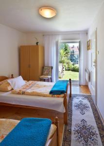 a bedroom with a bed and a chair and a window at Privát U Čejků in Telč