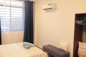 a small room with a bed and a window at Salasala Suites, Salasala, Mbezi Beach in Dar es Salaam