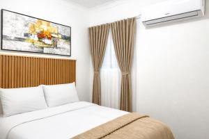 a bedroom with a bed and a tv on the wall at Bonno Guest Suite in Gaborone