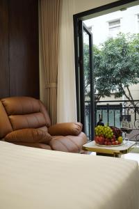 a bedroom with a bed and a table with fruit at Blubiz Hotel 9 in Hanoi
