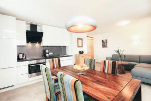 a kitchen and dining room with a wooden table and chairs at Luna Blanca - Apartment 2 in Schwangau