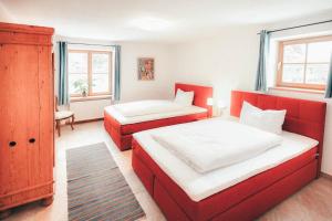 a bedroom with two beds and a dresser at Luna Blanca - Apartment 2 in Schwangau
