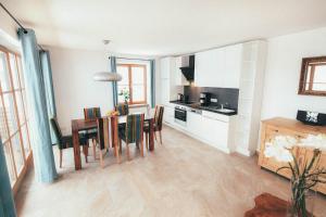 a kitchen and dining room with a table and chairs at Luna Blanca - Apartment 2 in Schwangau +7 photos
