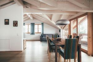 a dining room with a table and chairs at Luna Blanca - Apartment 3 in Schwangau +5 photos