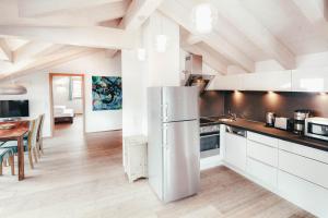 a kitchen with a refrigerator and a dining room at Luna Blanca - Apartment 3 in Schwangau