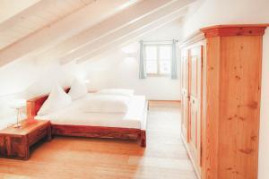 a bedroom with a white bed in a attic at Luna Blanca - Apartment 3 in Schwangau