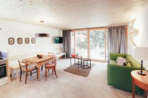 a living room with a table and a green couch at Luna Blanca Chalet in Schwangau