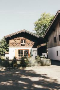 a house with a wooden fence in front of it at Luna Mia 1 Chalet in Schwangau +2 photos