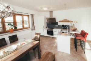 a kitchen with a table and a counter top at Luna Mia Apartment 2 in Schwangau
