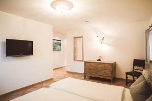 a living room with a tv on the wall at Luna Mia Apartment 2 in Schwangau