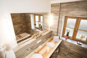 a bathroom with a tub and a sink and a bath tub at Luna Mia Apartment 2 in Schwangau +15 photos