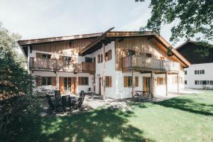 an exterior view of a house with chairs in the yard at Luna Mia Apartment 2 in Schwangau