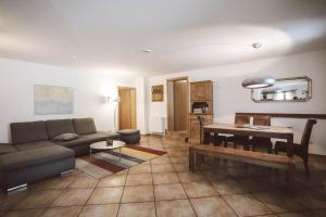 a living room with a couch and a table at Luna Mia Apartment 3 in Schwangau