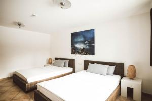 two beds in a room with white walls at Luna Mia Apartment 3 in Schwangau