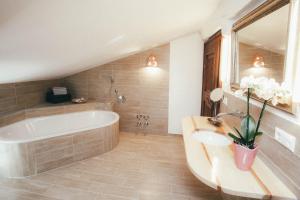 a large bathroom with a tub and a sink at Luna Mia Apartment 4 in Schwangau +20 photos