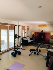 a living room with a gym with exercise equipment at Origin life in Ban Na Sat