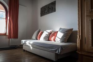 a couch with pillows on it in a room at Hopfenalm in Ilmmünster