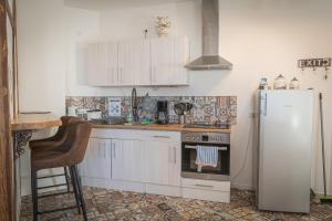 a kitchen with white cabinets and a refrigerator at Hopfenalm in Ilmmünster