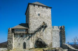 a large stone tower with a staircase on it at DiS Apartman in Vršac