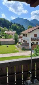 a house with a view of a yard at Ferienwohnung Bergblick in Marquartstein