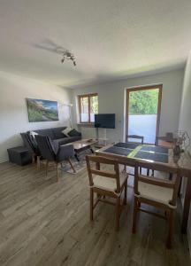 a living room with a table and a couch at Ferienwohnung Bergblick in Marquartstein