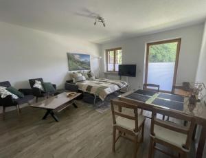 a living room with a couch and a table at Ferienwohnung Bergblick in Marquartstein