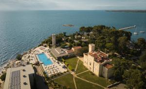 an aerial view of a mansion on the water at Isabella Island Miramare Suites & Villas, Valamar Collection in Poreč