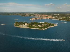 an island in the middle of a large body of water at Isabella Island Miramare Suites & Villas, Valamar Collection in Poreč