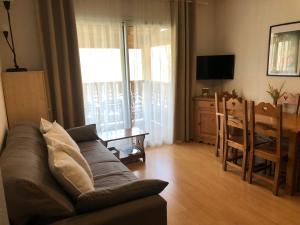 a living room with a couch and a table at T2 tout confort Ax les thermes in Ax-les-Thermes
