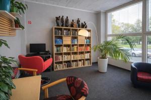 a living room with a book shelf filled with books at Hotel Kristína in Dubnica nad Váhom
