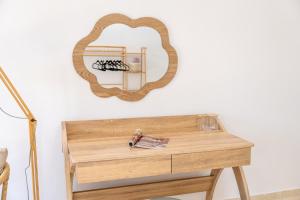 a dressing table with a mirror on a wall at Avra Charming House in Khelmáta