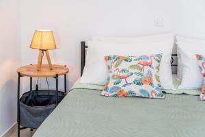 a bedroom with a bed with a lamp on a table at Avra Charming House in Khelmáta
