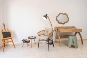 a room with a desk and a chair and a lamp at Avra Charming House in Khelmáta