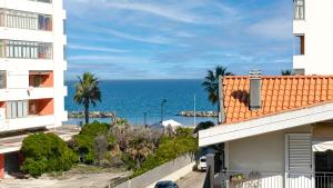 a view of the ocean from between two buildings at Platinum House in Montesilvano