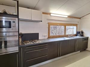 a kitchen with stainless steel appliances and a window at Les Renaudières Chalais in Chalais