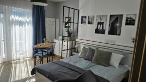 a bedroom with a bed and a table in it at Sunlight Apartmanház in Velence
