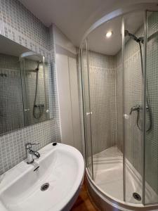 a bathroom with a shower and a sink and a glass shower stall at Casa Miradell in Hoz de Jaca +29 photos