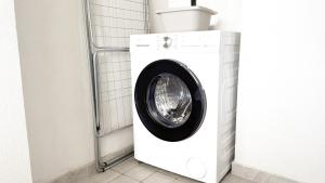 a white washing machine sitting in a bathroom at Platinum House in Montesilvano