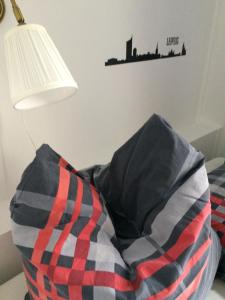 ein Bett mit einem Kissen und eine Lampe mit einer Stadt an der Wand in der Unterkunft LE-Citywohnung-I in Leipzig