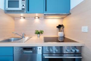 a kitchen with a sink and a stove at Waldstraße 2 Windrose Kellenhusen in Kellenhusen