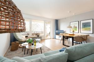 a living room with a couch and a table at Waldstraße 2 Windrose Kellenhusen in Kellenhusen