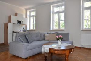 a living room with a couch and a coffee table at Pension Alte Flugleitung in Stendal