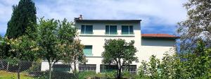 a man sitting on top of a white building at La Villa Pauze in Royat +2 photos