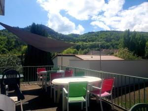 a patio with tables and chairs on a balcony at La Villa Pauze in Royat
