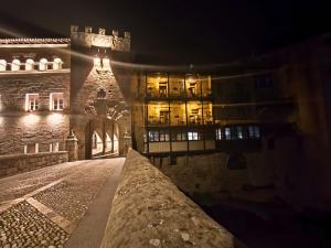 an old building at night with lights on at Fonda la Plaza in Valderrobres