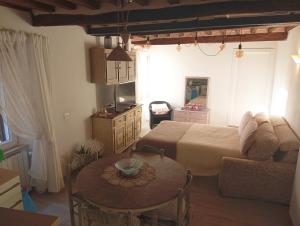 a living room with a bed and a table at Casa Giovy in Roccastrada