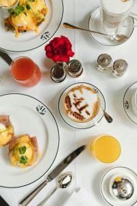 a table with plates of food and cups of coffee at 41 in London